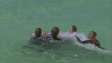 marine scientists beside zodiac with captured dugong apply satellite collar