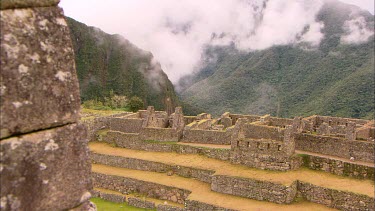 The ruins of Machu Picchu with cloud covered mountains in the back ground