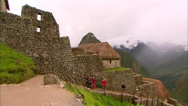 Tourists walking on a staircase in Machu Piccu