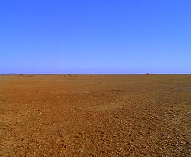 Desert and sun. Only sand and rock, no vegetation at all. Barren landscape. eerie empty lonely