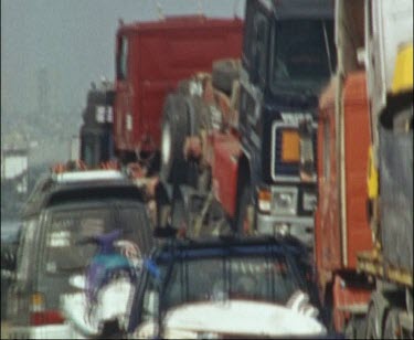 Grainy Shot Of Traffic Jam On A Busy Road, Surfboards in Truck