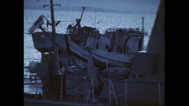 Closeups of Australian navy ship next to boat of illegal clam poachers