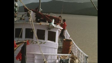Taiwanese clam poachers aboard their boat