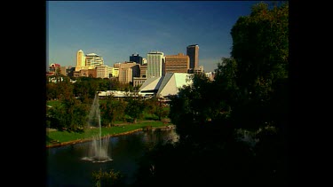 Adelaide, city and Torrens River and park. Fountain in river.