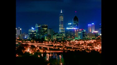 Perth time lapse at night. Highway system with bright lights in FG.
