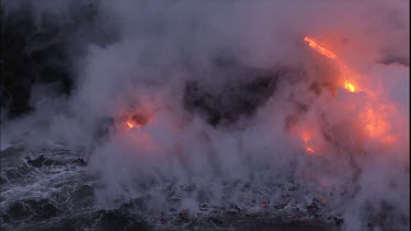 CU steam at edge of lava delta and incandescent lava flow. It looks like flames but its not - its the molten rock of the lava flow.