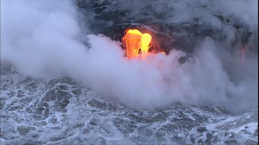 CU Lava flow, lava crust, lava delta and steam. Lava flowing directly into ocean in two streams. Lavafall like waterfall.