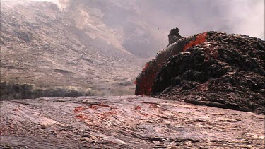 Lava bubbling and erupting from vent and flowing down lava channel