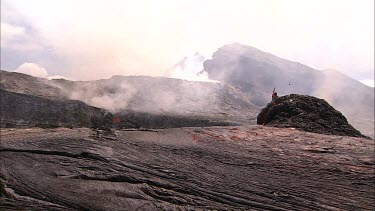 Lava bubbling and erupting from vent and flowing down lava channel