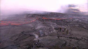 Scientists  and filmmakers filming on active lava field