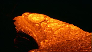 Incandescent lava erupting out of a fissure. Night.  Bubbling