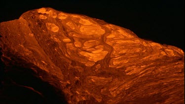 Incandescent lava erupting out of a fissure. Night.  Bubbling