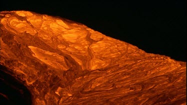 Incandescent lava erupting out of a fissure. Night.  Bubbling
