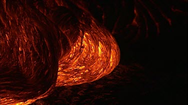 The molten rock incandescent lava moving across the surface. It looks plastic in form, soft and maleable as if it is being extruded.