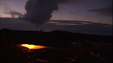 Establishing shot. Bubbling incandescent lava. Background with smoke rising from caldera.