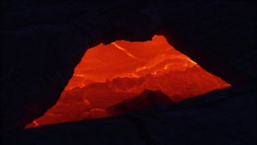 Looking into a lava tube, as if looking into the surface of the earth and seeing the magma, incandescent and alive.
