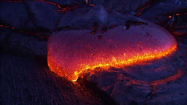 Incandescent lava seeping from a fissure.