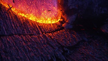 Incandescent lava seeping from a fissure.