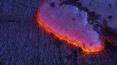 Incandescent lava seeping from a fissure. Zoom in to ECU