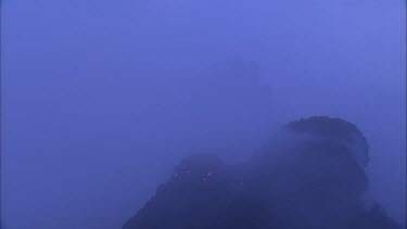 Lava sputtering and erupting out of a vent. Volcanic eruption. Smokey eerie landscape
