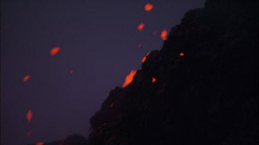 Lava sputtering and erupting out of a vent. Volcanic eruption. Smokey eerie landscape
