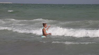 Lady Walks Into Sea In Bikini, Lido, Venice, Italy