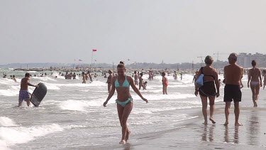 Woman In Light Green Bikini Runs On Beach, Lido, Venice, Italy