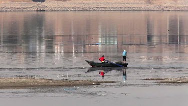 Fishermen On Rowing Boat Putting Out Nets, River Nile, Luxor, Egypt