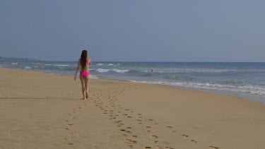 Woman In Pink Bikini Walks Along Beach, Bentota, Sri Lanka