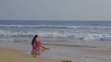Model Sat In Indian Ocean Surf, Bentota, Sri Lanka